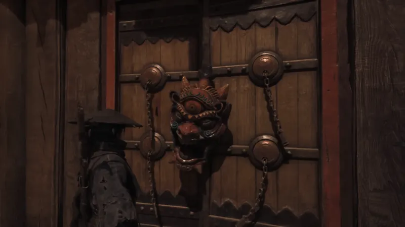A figure at a door with a beast-faced door ornament.