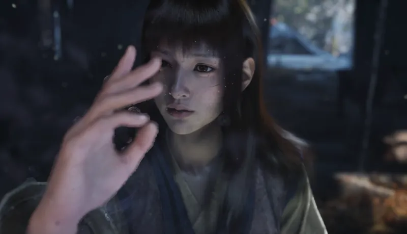 A young woman raising a hand to her face.