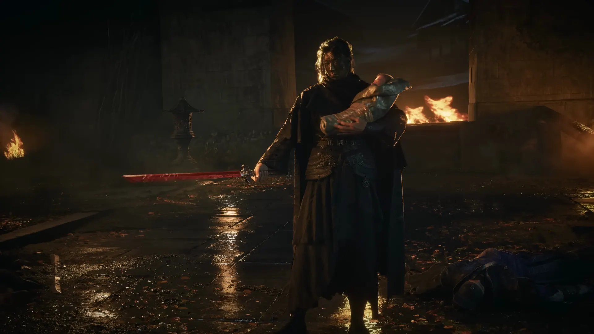 A long-haired figure holds an infant in one arm and a red blade in the other, in a burning courtyard at night.