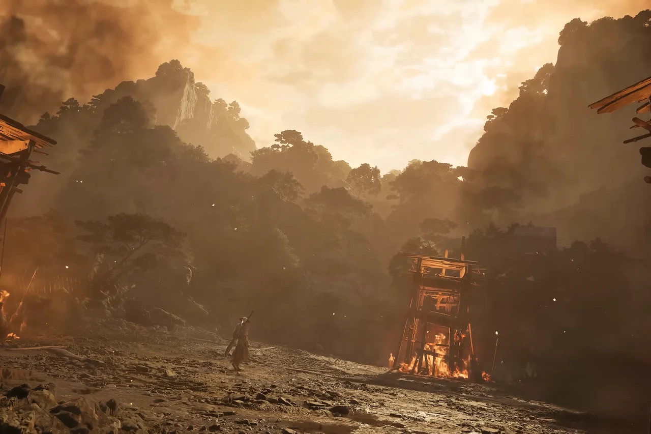 Wide view of a muddy arena with a burning wooden tower.