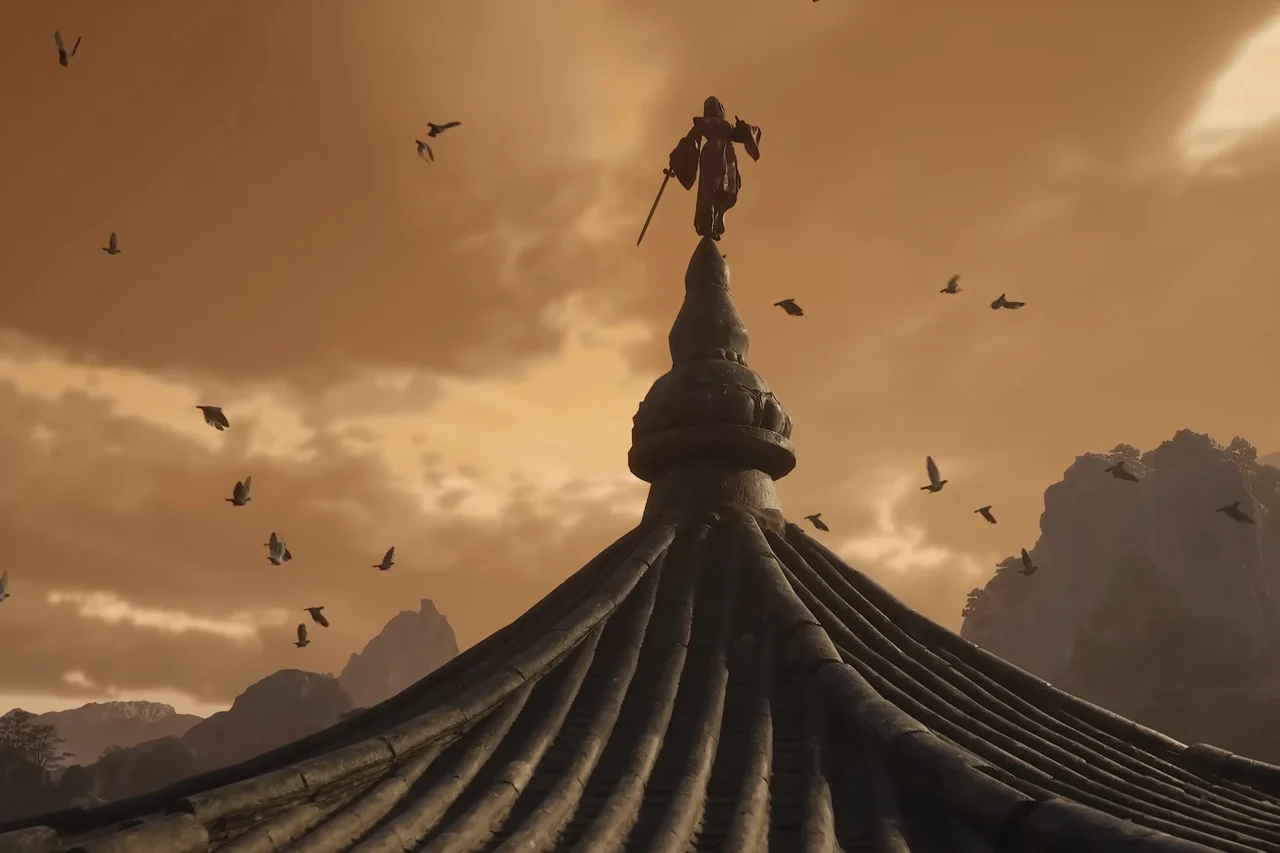 A small figure stands on the spire of a tiled roof against a hazy sky.
