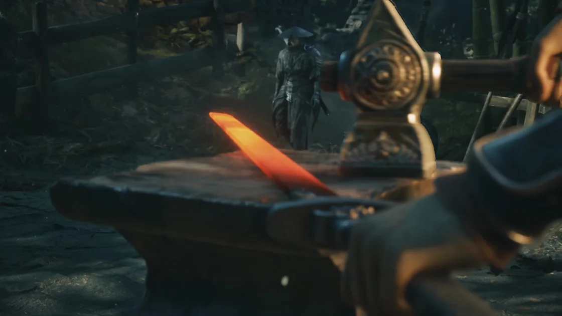 Close-up of a hammer, an anvil and a red-hot metal bar.