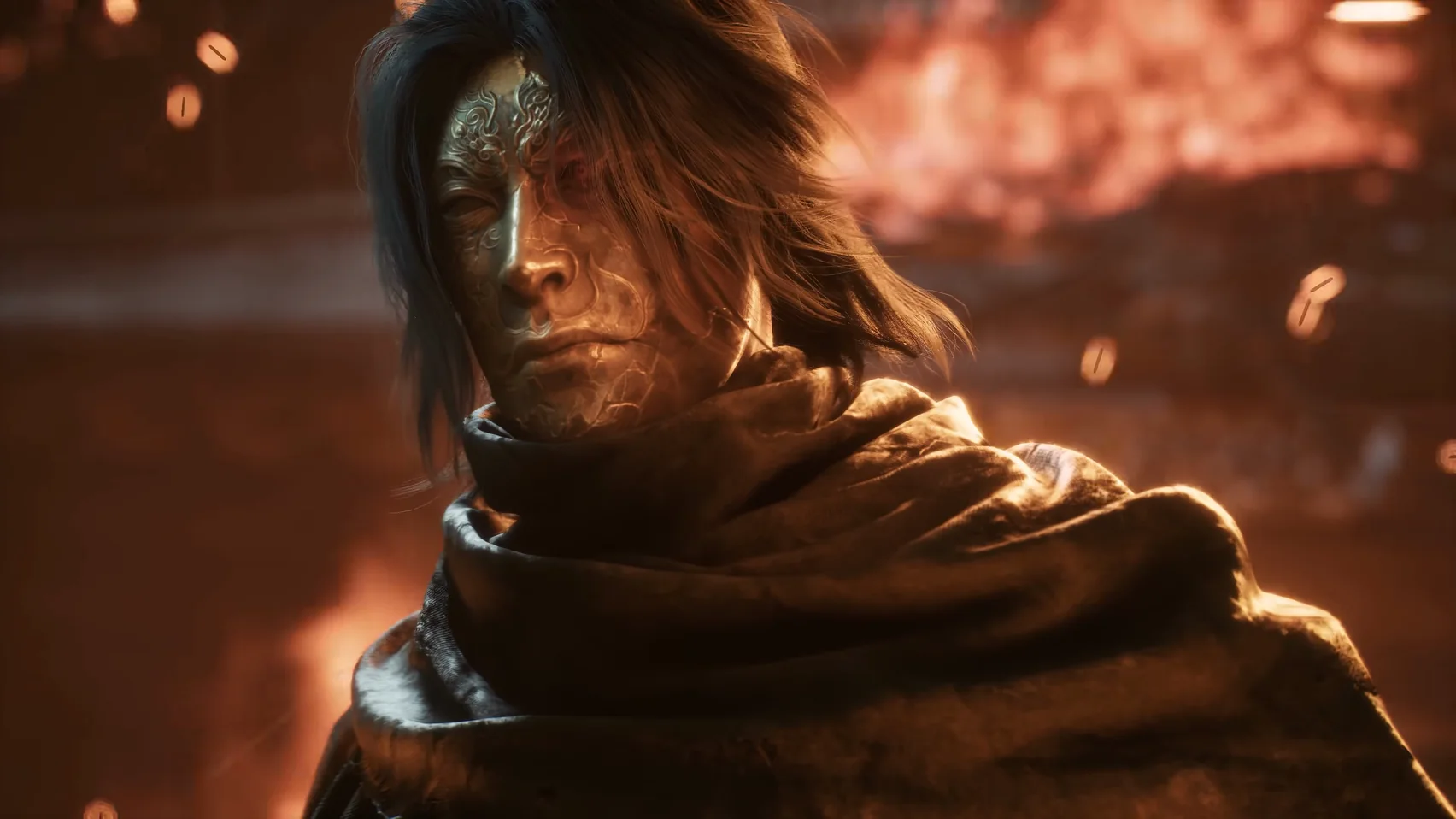 Close-up of a long-haired man with gold markings on his face; fire behind him.