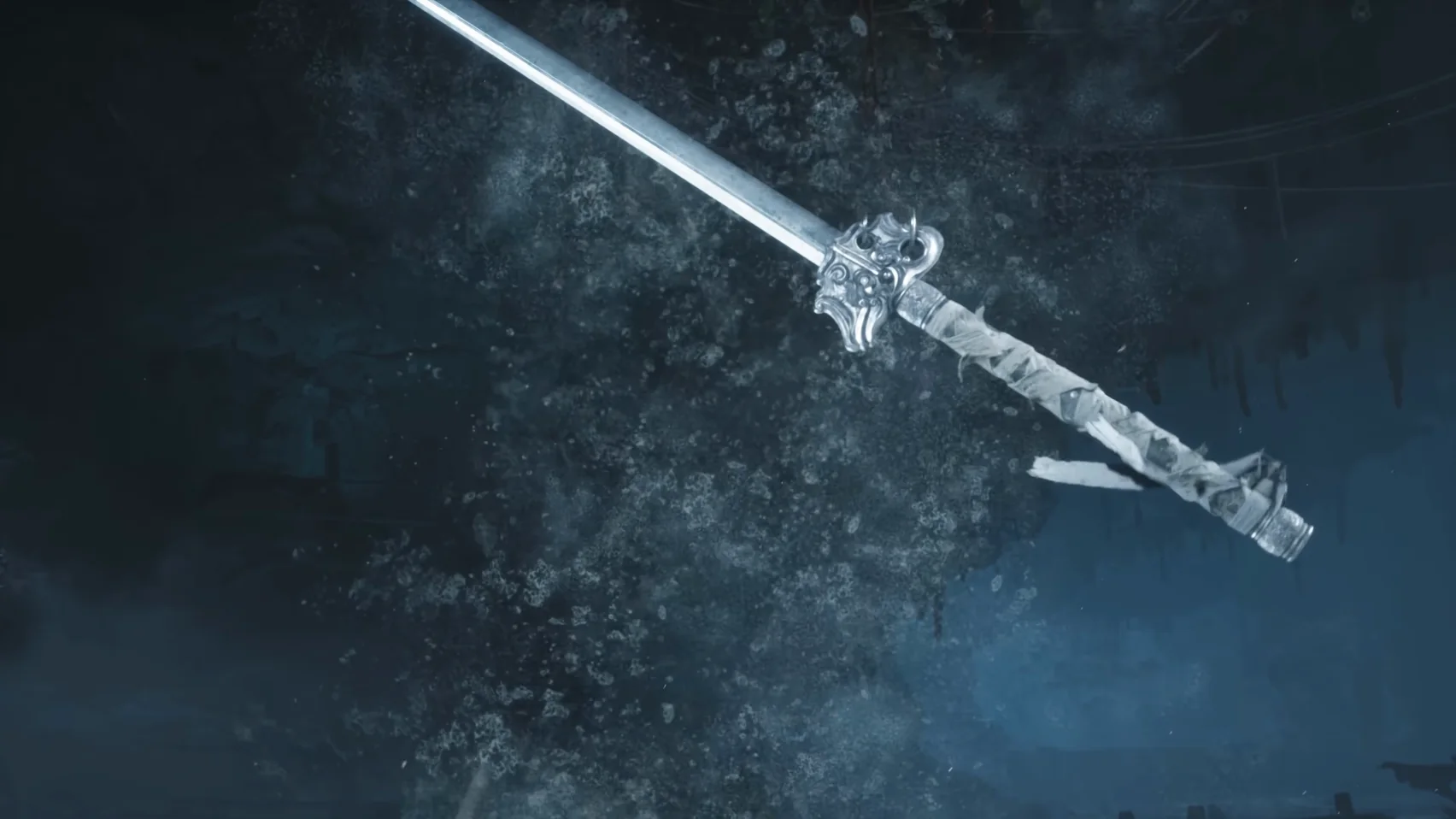 Close-up of a long blade, its hilt wrapped in white, with a carved metal guard.