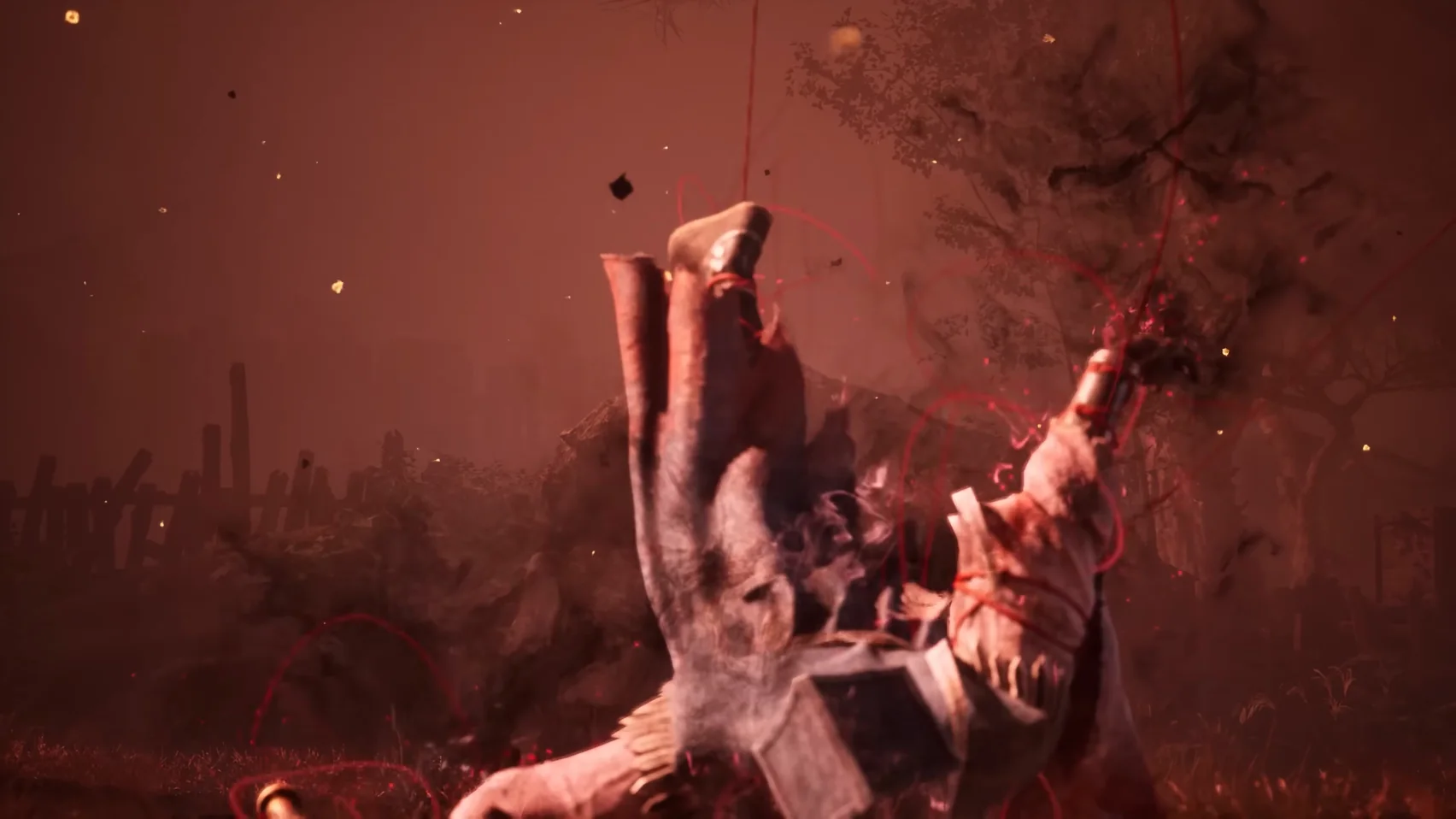 A figure hangs upside down in a red scene, red lines running from it in every direction.