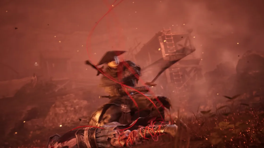 Close-up of the straw-hatted figure with a red thread wound around an arm and across the body.