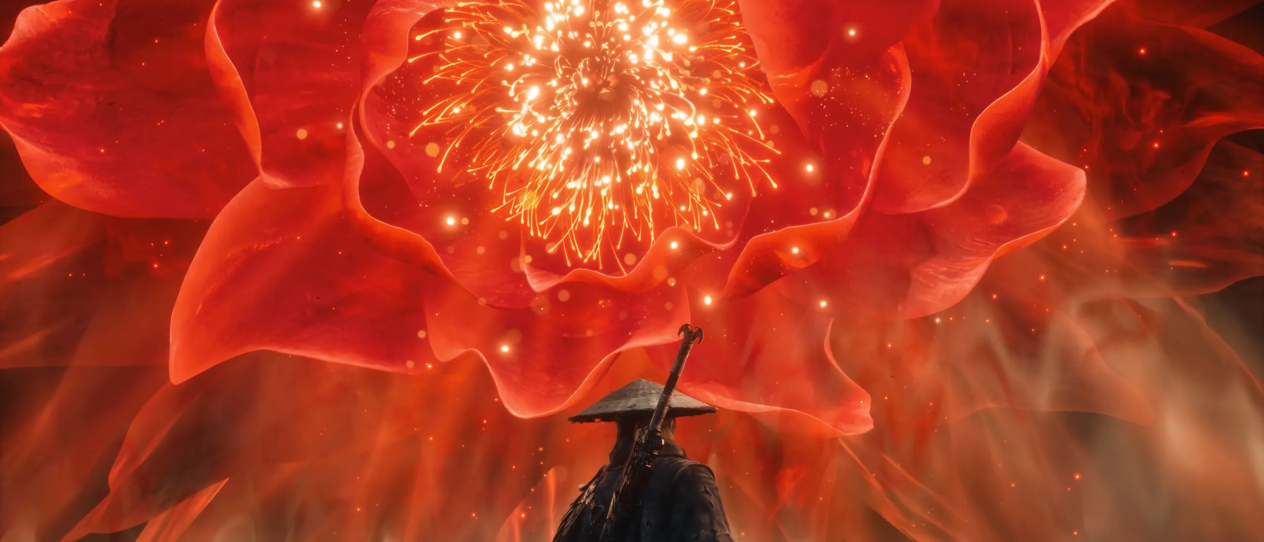 A huge red flower of light bursts open behind a small figure in a straw hat seen from behind.