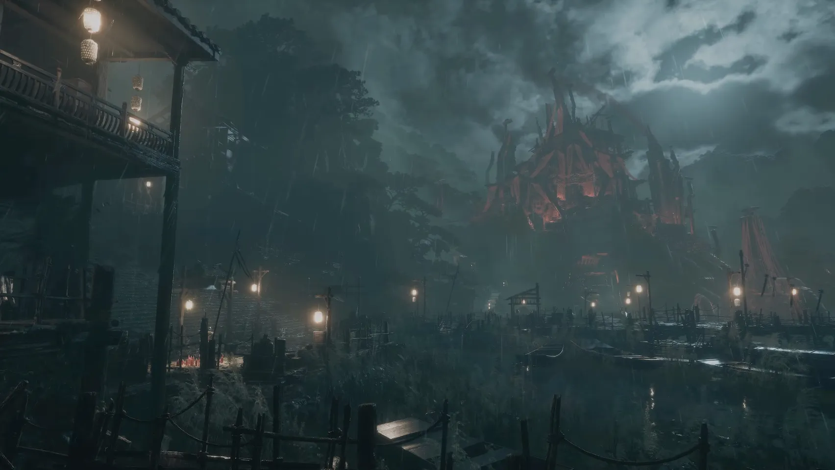 A walled town of wooden houses and lanterns in heavy rain, a large building glowing red behind it.