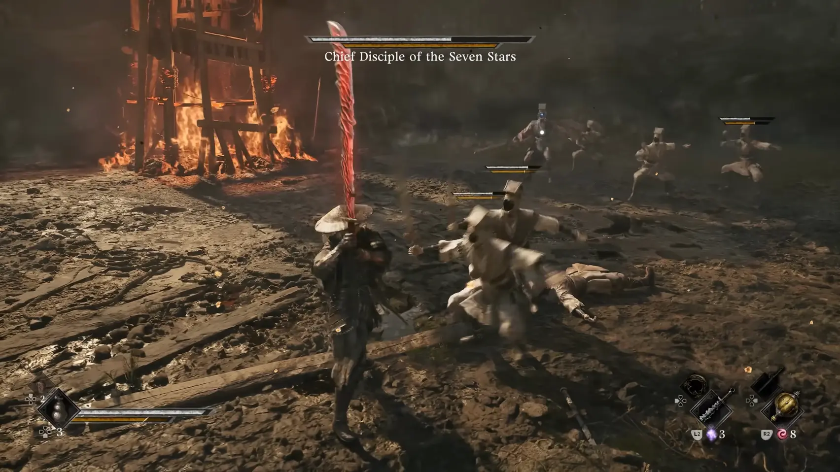A figure with a raised blade stands over a fallen swordsman; more pale figures run in from a burning tower.